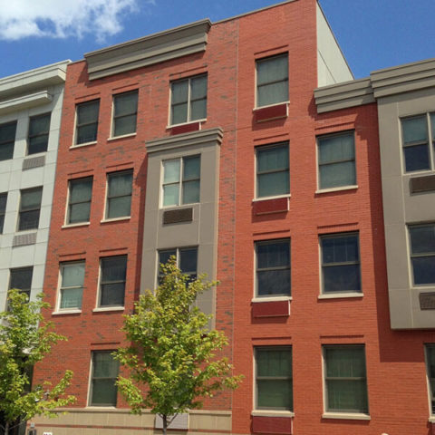 A Red Brick Building with a Classic Design and Large Windows by HS Windows